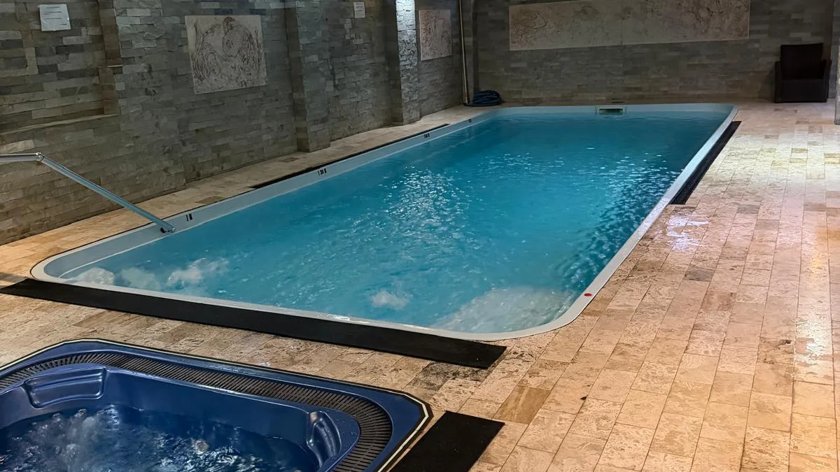 Piscina interioară încălzită, cu pereți din piatră și basoreliefuri